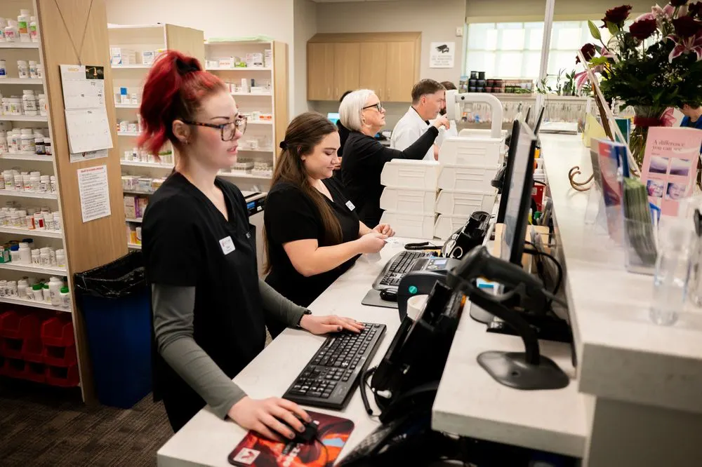Jolley's Sandy Pharmacy team working together behind the prescription counter