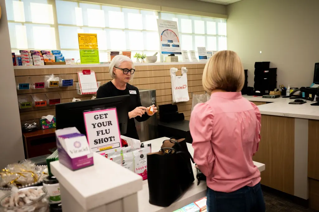 A Jolley's team member helping a customer at the pharmacy counter