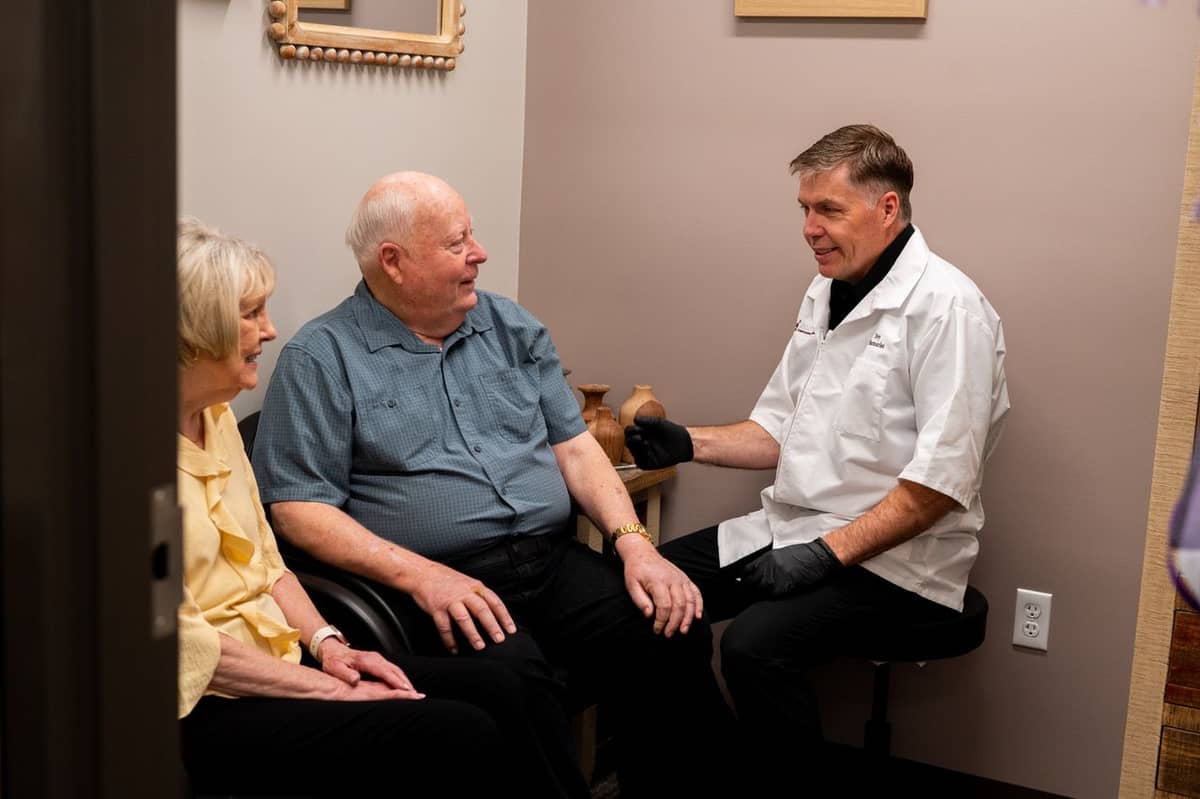 A Jolley's pharmacist meeting with two patients to discuss their care